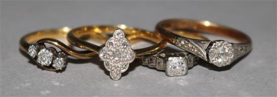 Four assorted 18ct gold and diamond set dress rings.